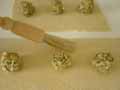 Brushing the egg white in between the tortelli mounds Brushing the egg white in between the tortelli mounds