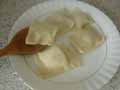 Spooning tortelli onto plate Spooning tortelli onto plate