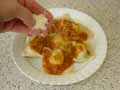 Sprinkle grated Parmesan cheese over tortelli Sprinkle grated Parmesan cheese over tortelli